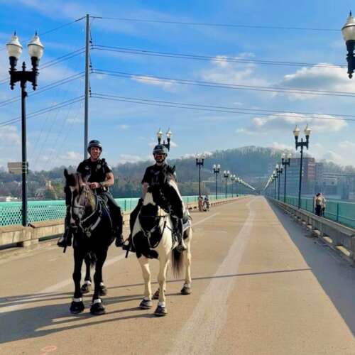 Mounted police officers riding horses across Gay Street Bridge in Knoxville Tennessee