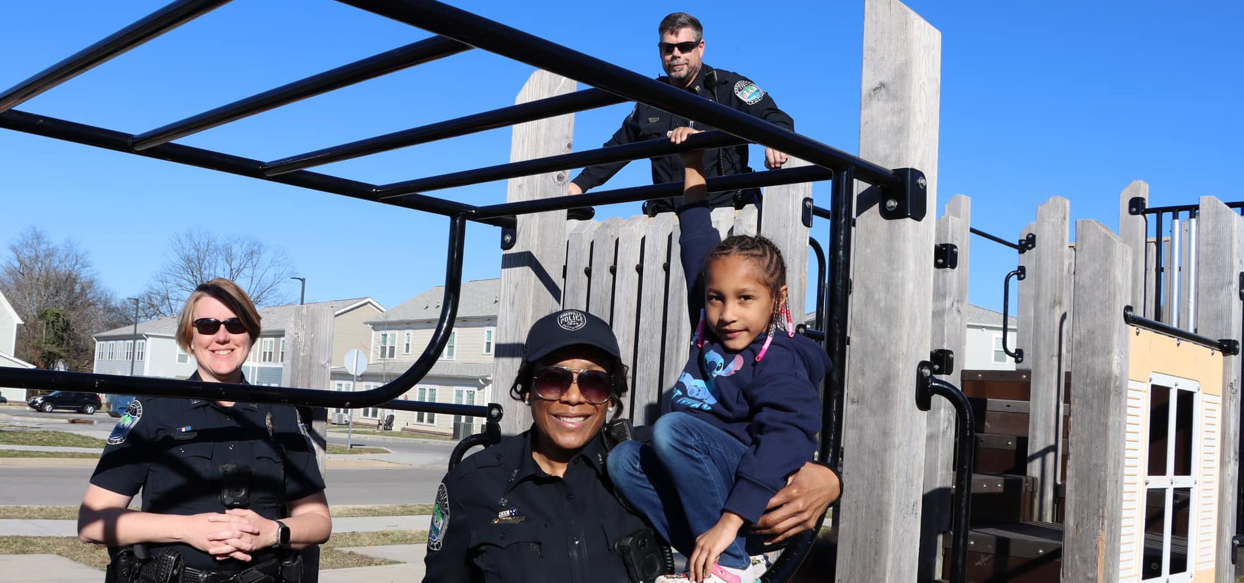 Police officers supporting youth activities at a local playground