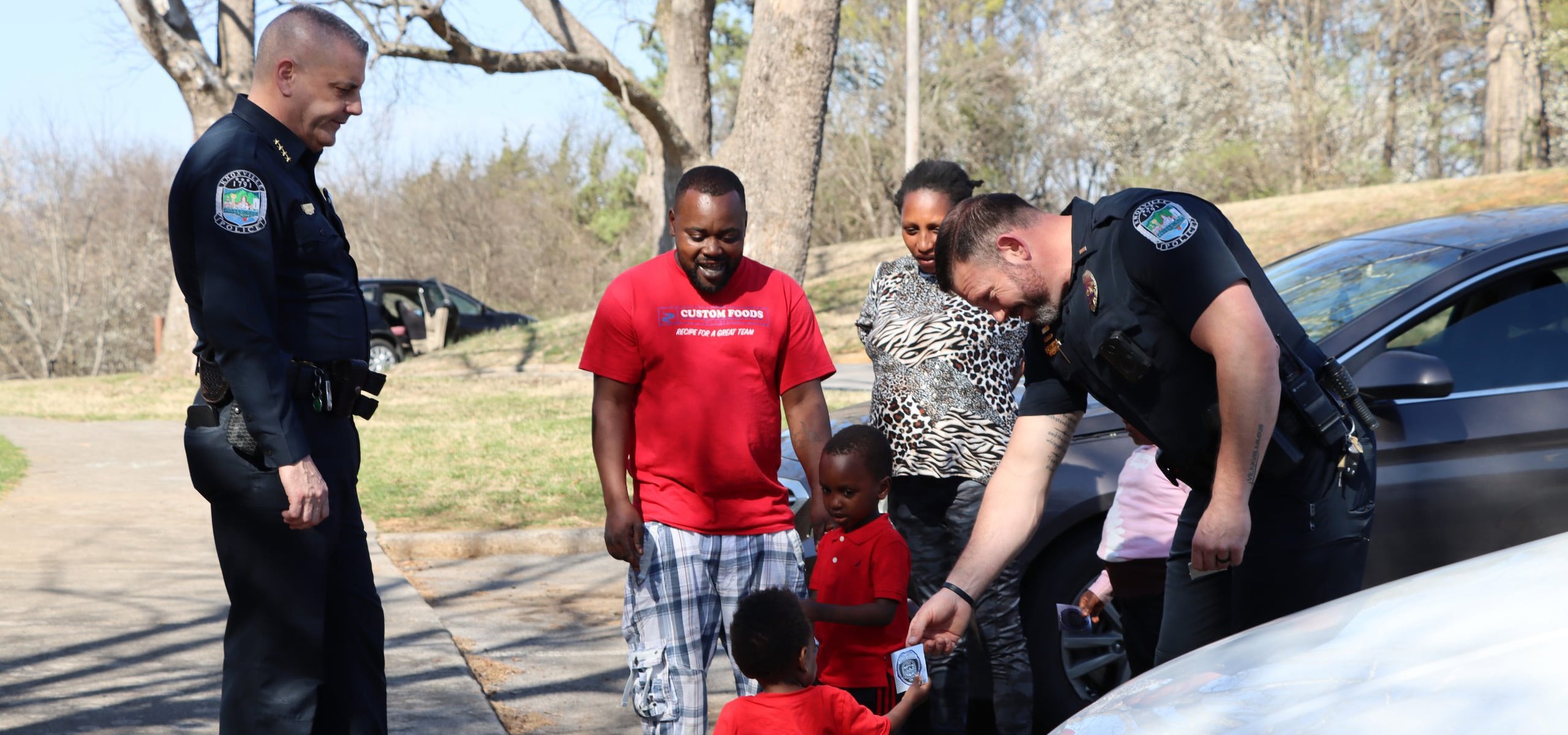 Police officers engaging with children and families during a community outreach