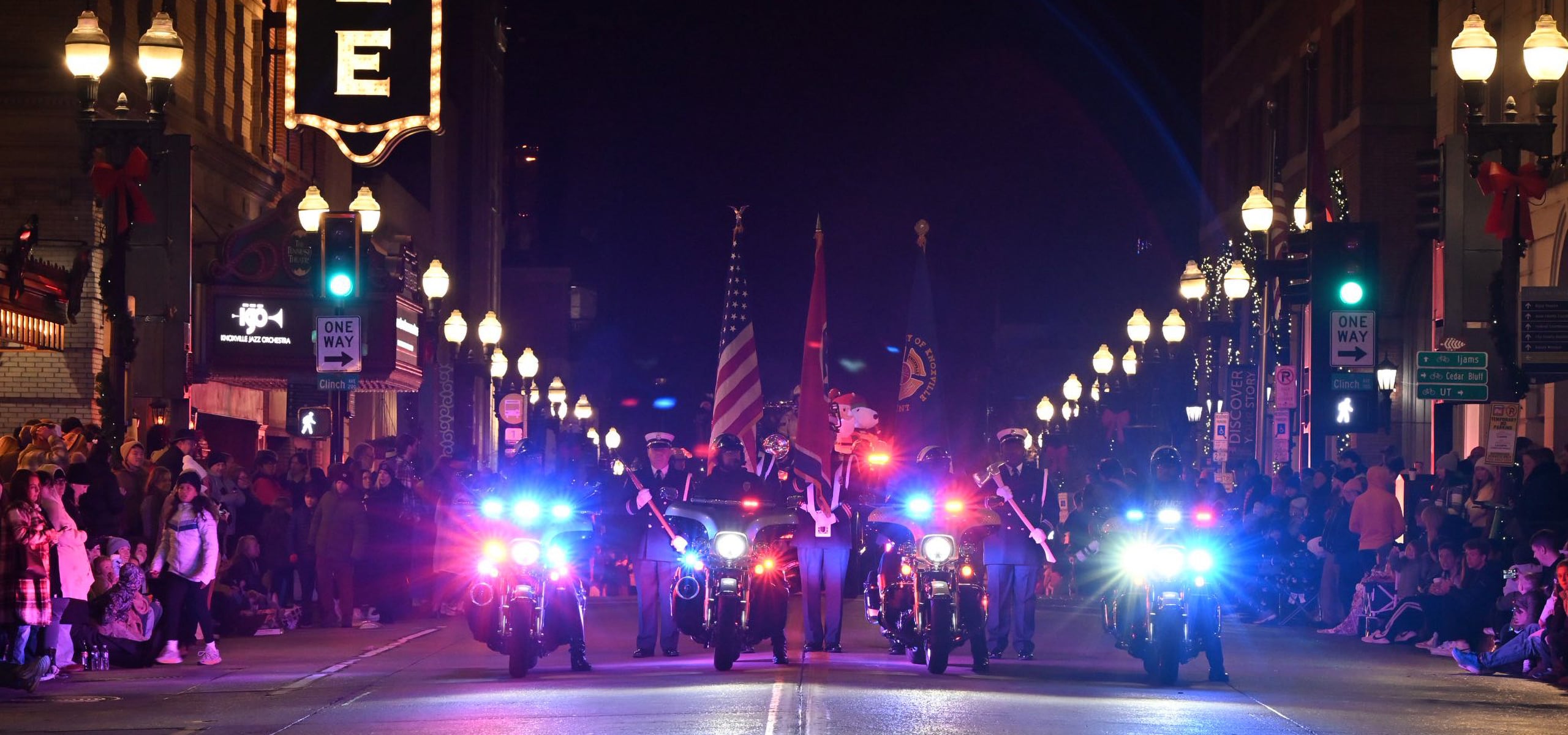 Motorcycle officers leading a parade with flashing lights