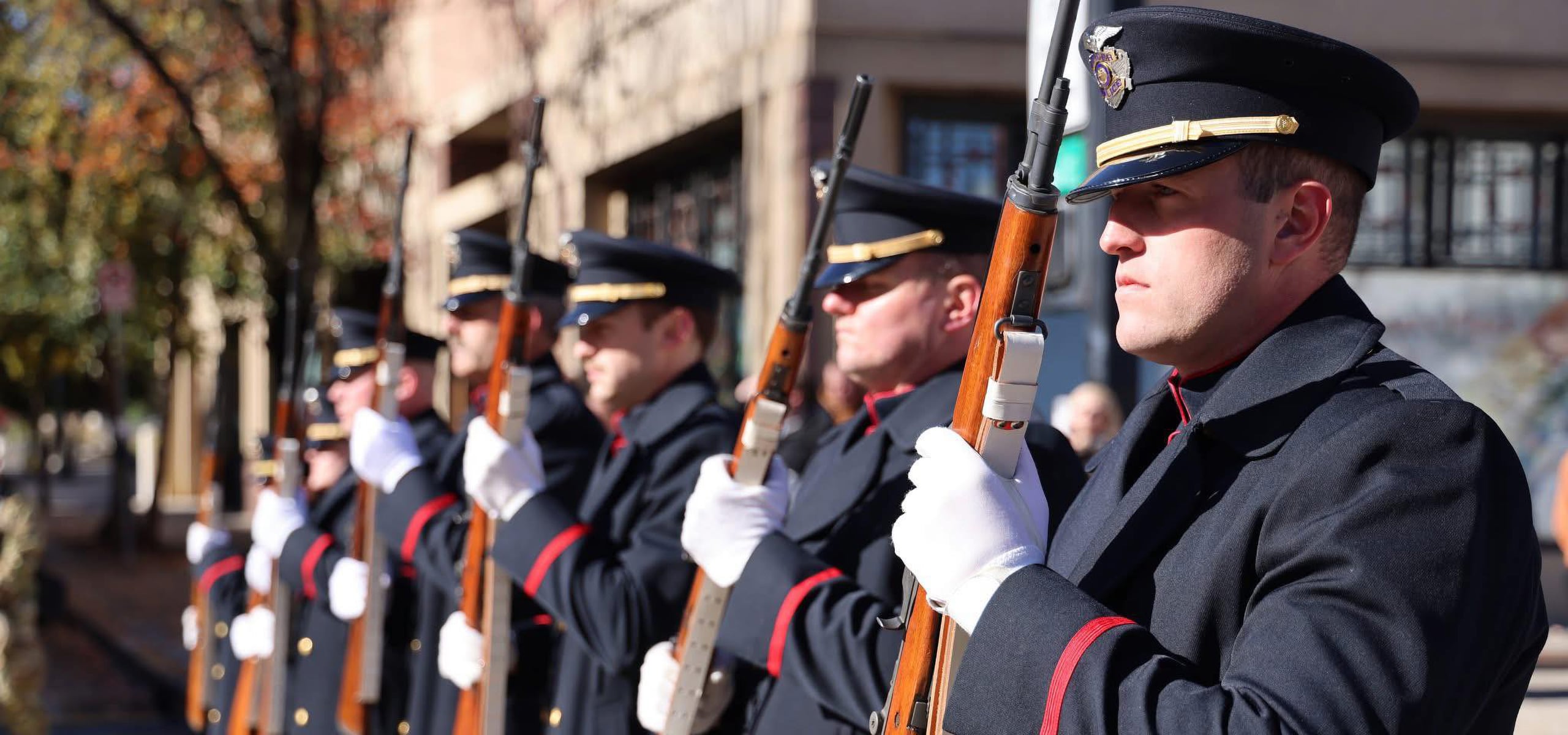 Police Officers lined up for a parade, displaying their rifles